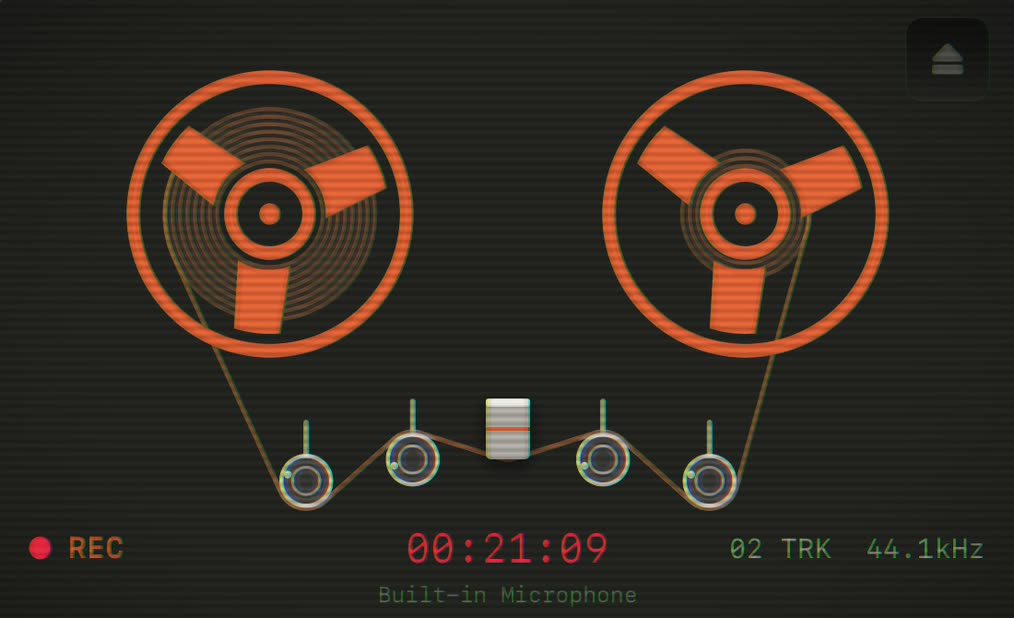 Oxyde tape reels glowing orange on the dark deck, REC lit