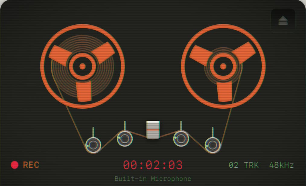 Oxyde tape reels glowing orange on the dark deck, REC lit