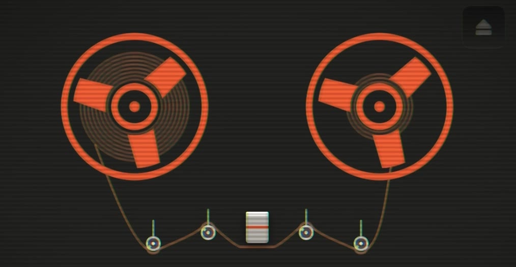 Oxyde tape reels glowing orange on the dark deck